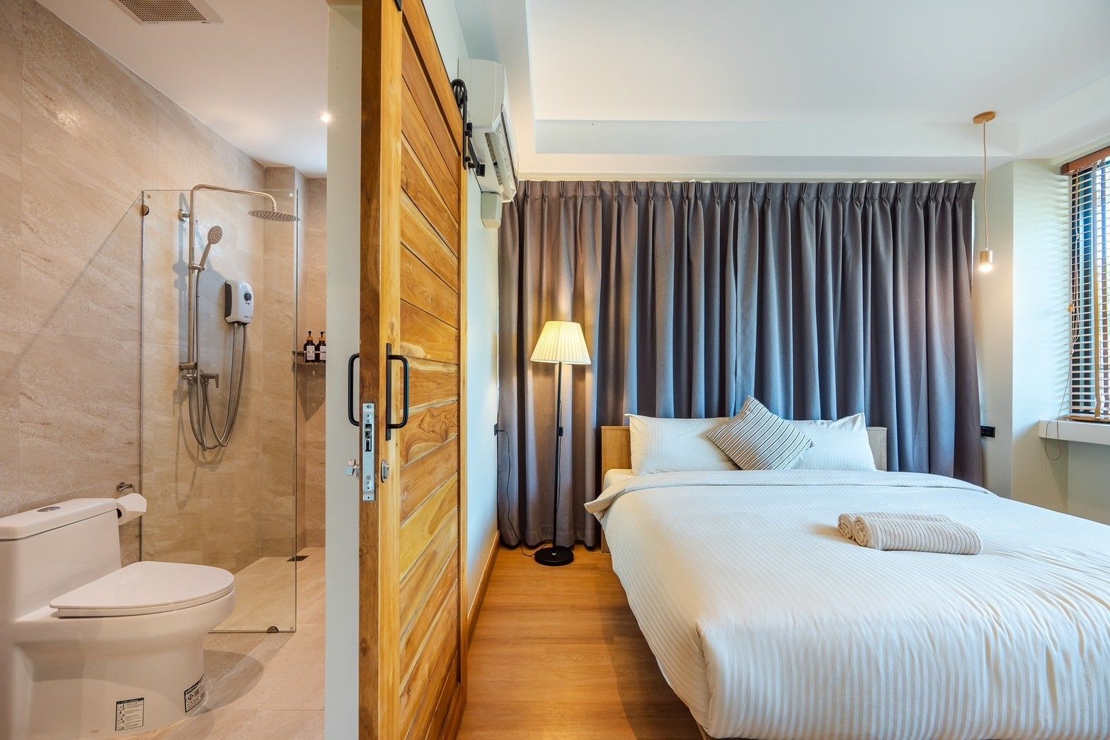 Bedroom with ensuite shower at All About VII Pool Villa, near Bangket Beach, Cha-am. King bed, wood sliding door.