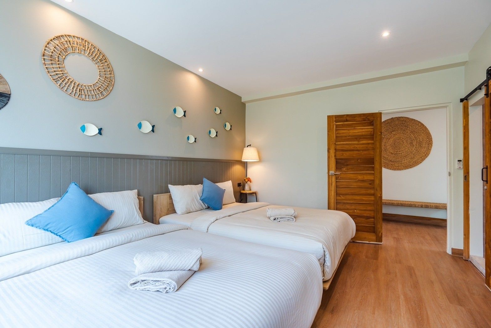 Twin beds with fish decor in All About VII Pool Villa, near Bangket Beach, Cha Am. Coastal style bedroom.