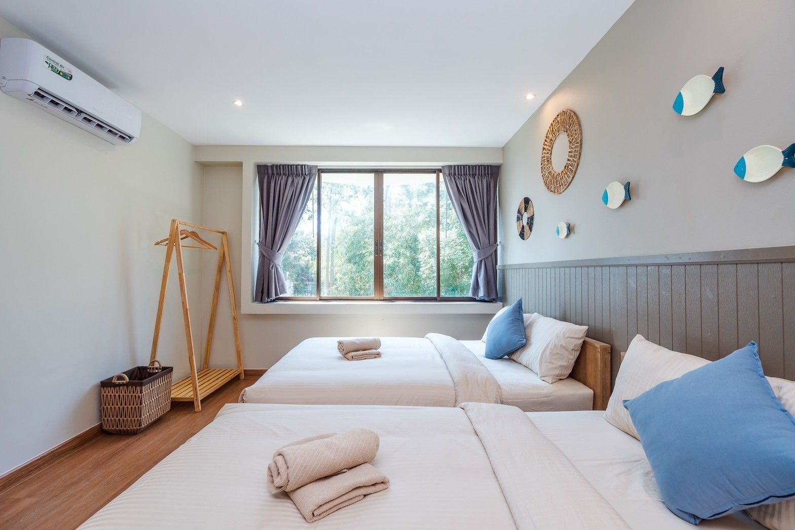 Twin beds in All About VII Pool Villa, near Bangket Beach, Cha-am. Window view, nautical decor, air conditioning.