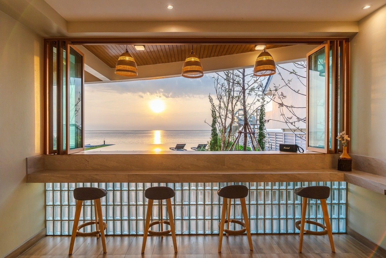 Breakfast bar with stools at All About VII Pool Villa, overlooking the ocean at sunset, near Bangket Beach, Cha Am.