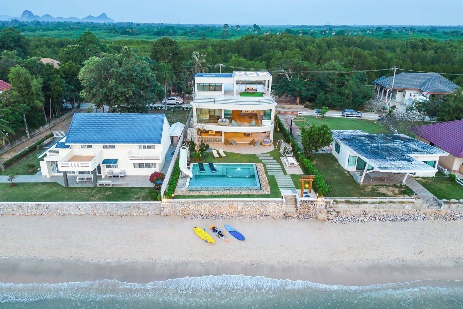 Aerial view of All About VII Pool Villa, beachfront in Cha Am. See the pool, beach access, and modern design.