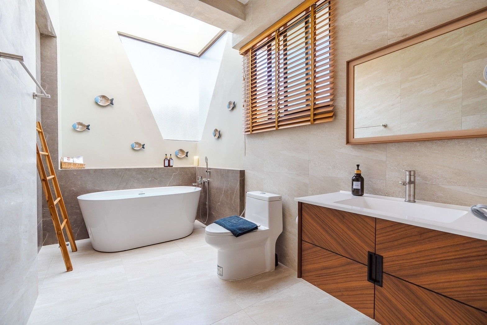 Modern bathroom with skylight at All About VII Pool Villa near Bangket Beach, Cha-am. Features a soaking tub and wood vanity.