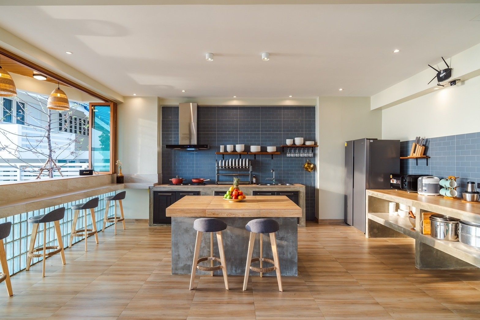 Modern kitchen at All About VII Pool Villa near Bangket Beach, Cha-am. Features island, bar seating, and stainless steel appl