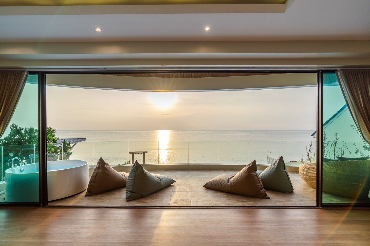 Ocean view balcony with beanbag chairs at All About VII Pool Villa, near Bangket Beach, Cha Am.