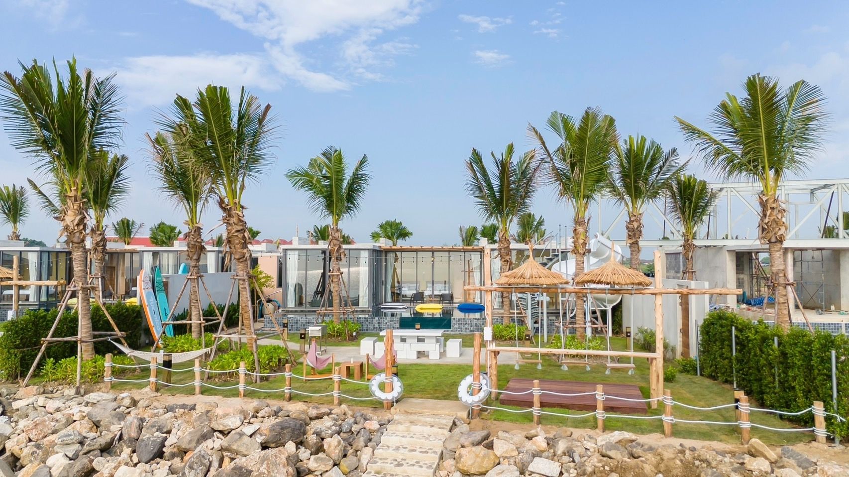 Beachfront play area at Amore' A Pool Villa, หาดปึกเตียน-ชะอำ. Features swings, hammocks, and a slide for family fun.