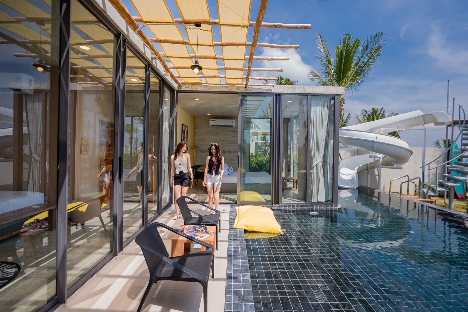 Amore' A Pool Villa poolside view with glass doors and water slide in หาดปึกเตียน-ชะอำ, Thailand.