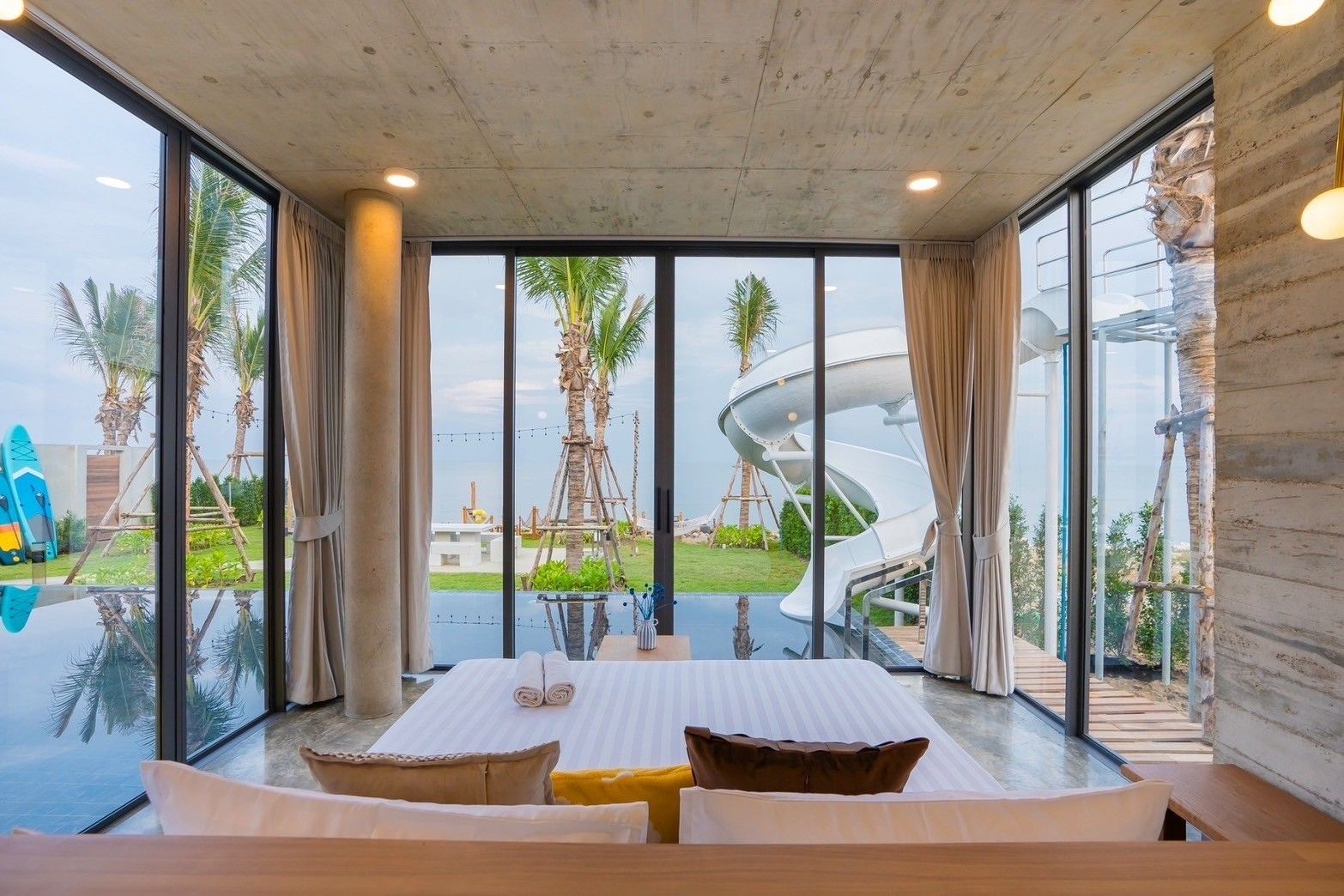 Amore' B Pool Villa, Cha-Am bedroom with pool view and waterslide access.