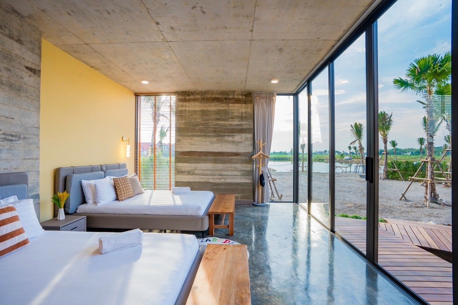 Amore' B Pool Villa, Cha-Am bedroom with twin beds and lake view through large windows.