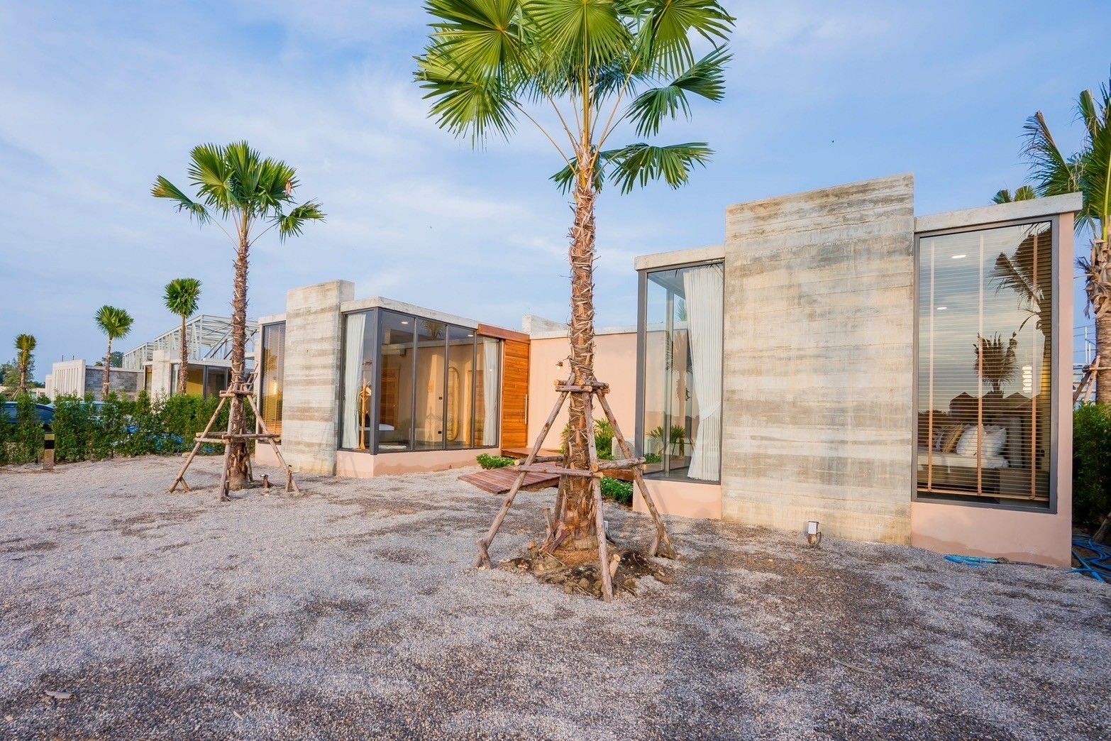 Amore' B Pool Villa, Cha-Am exterior with modern concrete design and palm trees.