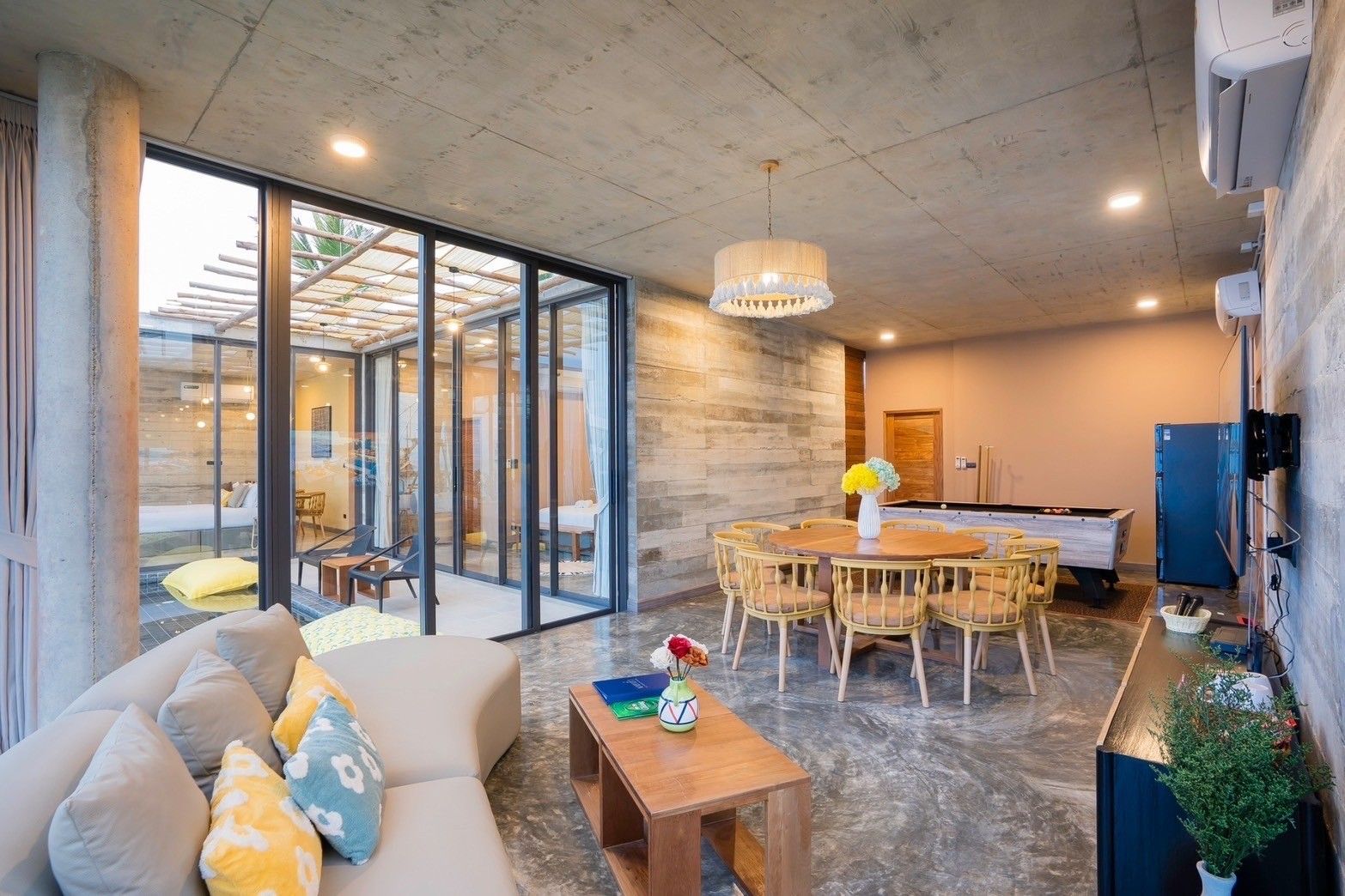 Amore' B Pool Villa, Cha-Am open plan living area with dining table, sofa, and pool table.