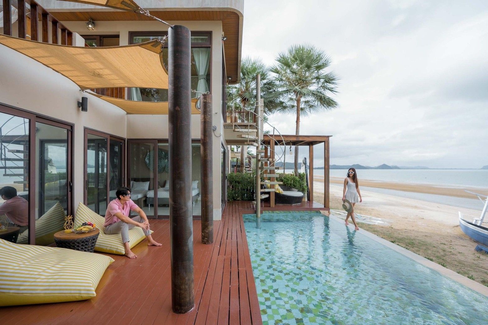 Aqua Pran II pool villa beachfront infinity pool with spiral staircase, เขาสามร้อยยอด ปราณฯ. People relaxing by the pool.