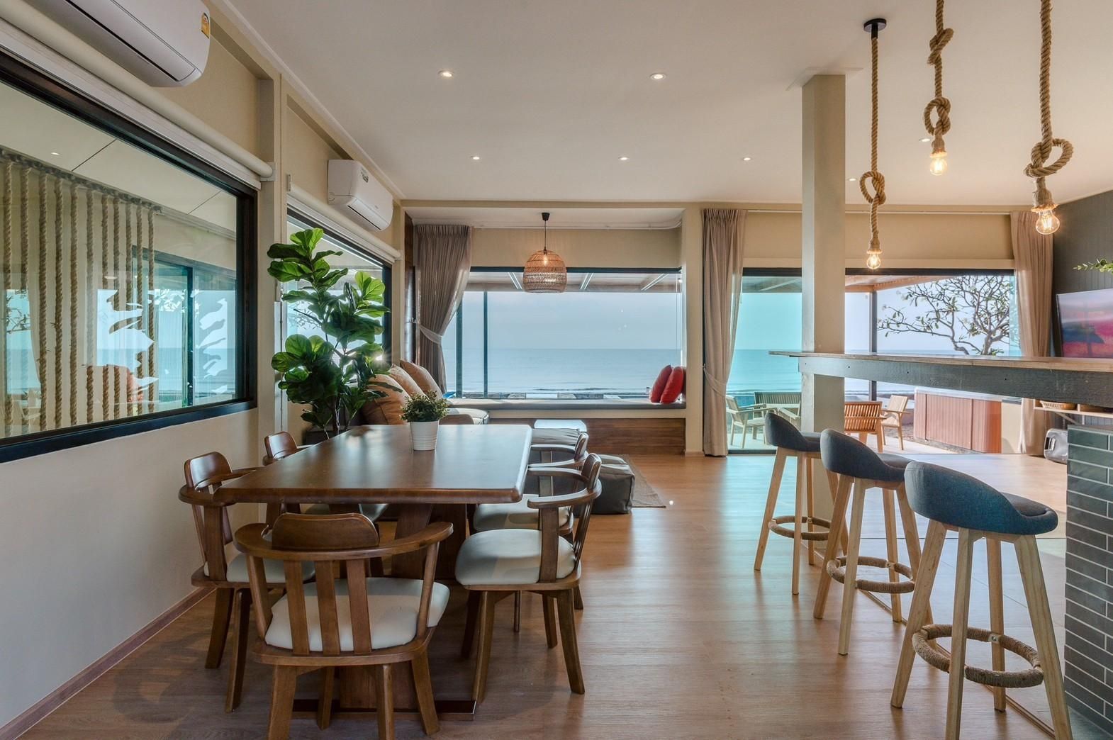 Dining table with ocean view at Beach Blanca IV pool villa in Cha-Am. Coastal decor and natural light.