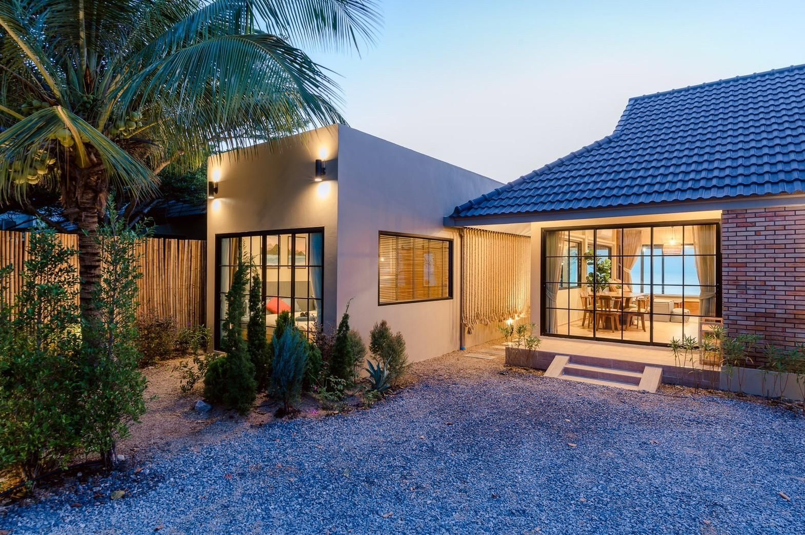 Beach Blanca IV Pool Villa exterior in Cha-Am, Thailand. View of the front garden and villa facade at dusk.