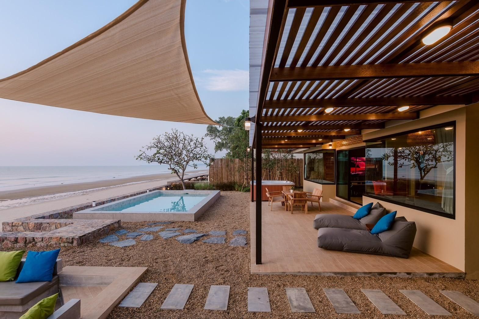 Beach Blanca IV pool villa in Cha-Am features a beachfront patio with lounge seating and a small pool.