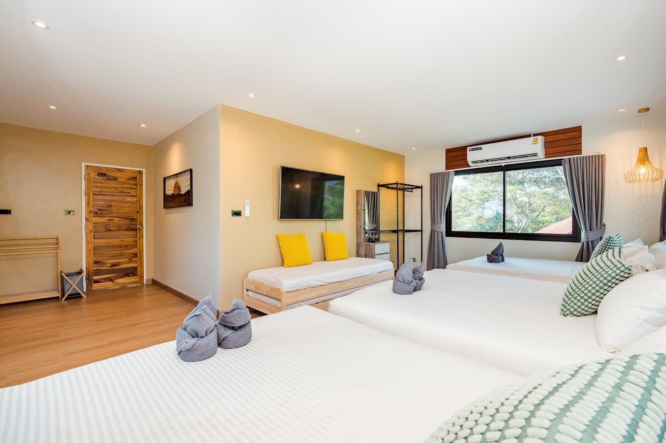 Bright bedroom with three single beds at Beach Mood VI Pool Villa, หาดบางเกตุ ชะอำ. Features TV, daybed, and nature view.
