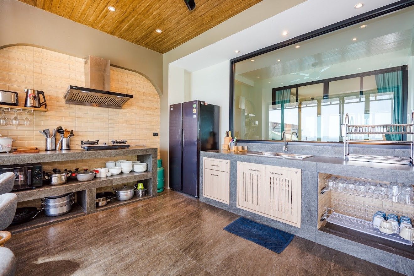 Modern kitchen with stone countertops at Beach Mood VI Pool Villa, หาดบางเกตุ ชะอำ. View of sink and cooking area.