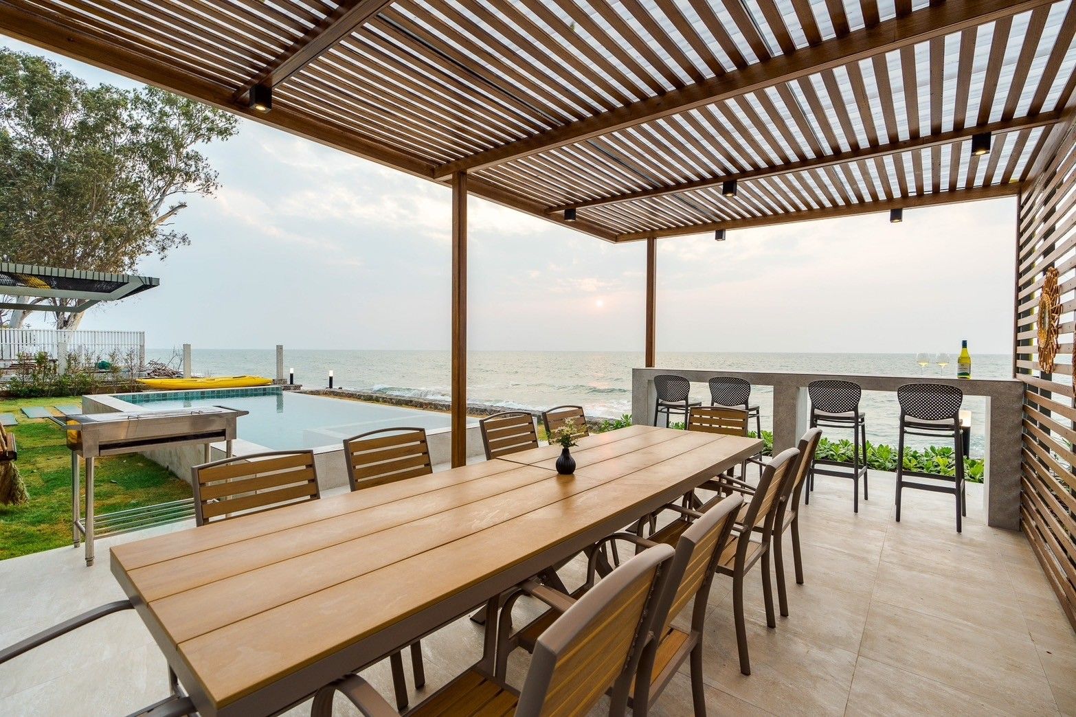 Beach Vibe-Two V Pool Villa dining area with ocean view in Cha Am, Thailand. Outdoor table with seating.