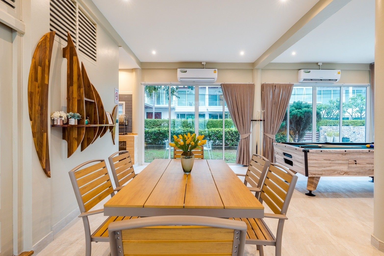 Dining area with wooden table and chairs at Beach Vibe-Two V Pool Villa, ติดทะเล ใกล้หาดบางเกตุ ชะอำ. View to pool table.