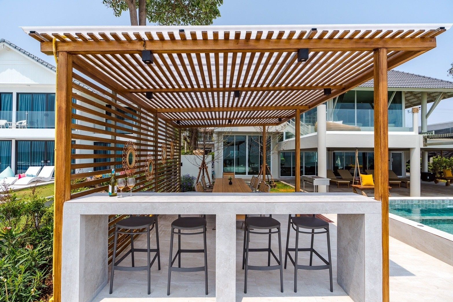 Outdoor bar area at Beach Vibe-Two V Pool Villa, ติดทะเล ใกล้หาดบางเกตุ ชะอำ. Features pergola, bar counter, and stools.