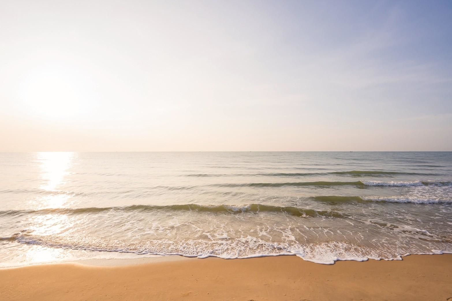 Beachfront view from Beyond V Pool Villa, หาดปึกเตียน-ชะอำ. Waves gently lapping the shore on a sunny day.