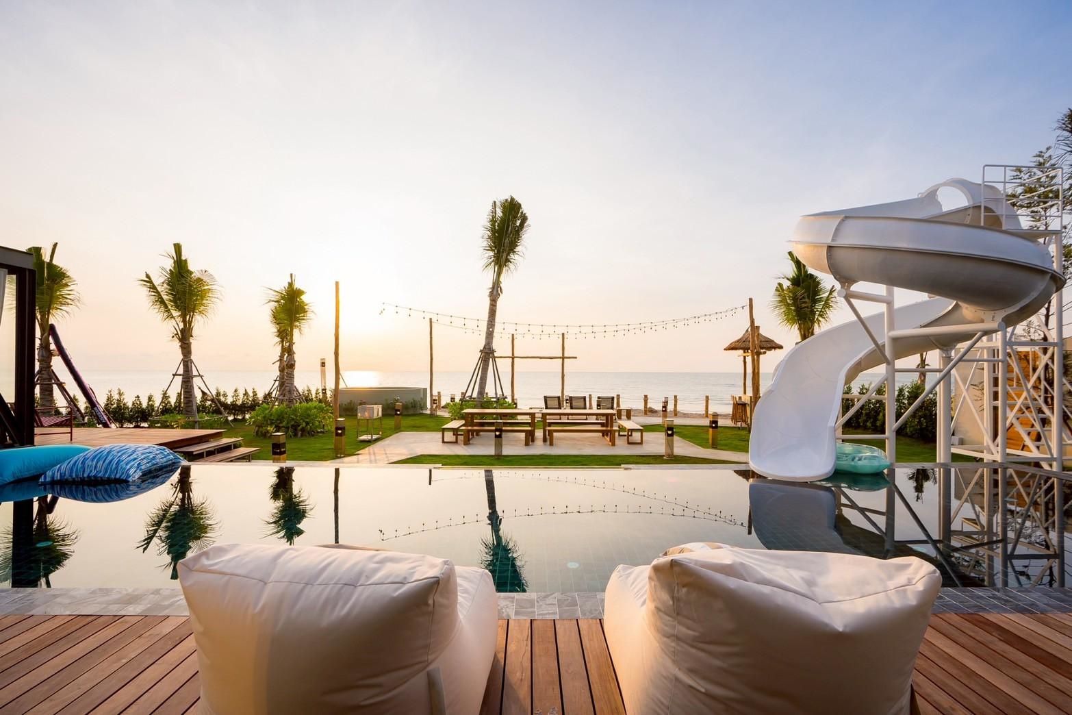 Beyond V Pool Villa pool view with slide and beanbag chairs, หาดปึกเตียน-ชะอำ. Relax by the pool at this beachfront villa.