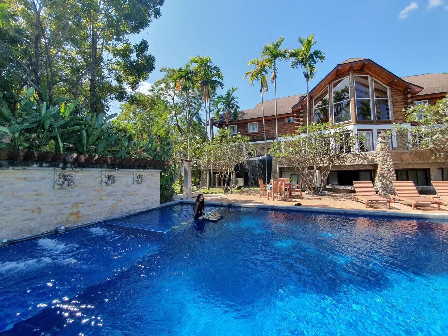 Log cabin villa facade with private pool at Cabin Pool Villa Khao Yai.