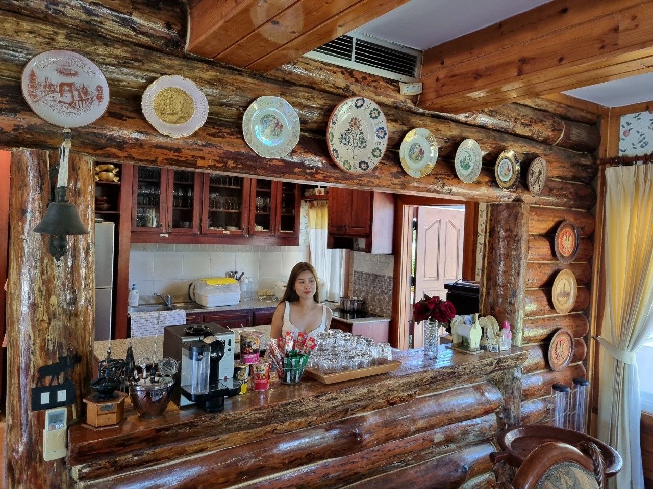 Rustic log cabin kitchen and bar counter at Cabin Pool Villa Khao Yai.