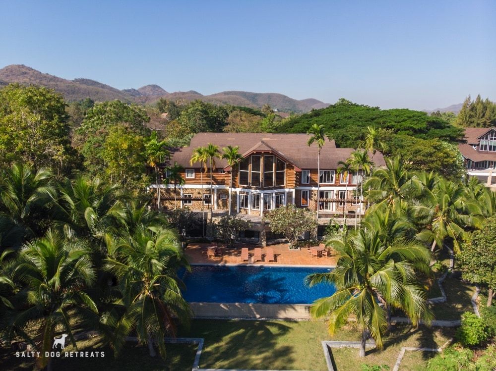 Aerial view of Cabin Pool Villa Khao Yai with pool and lush greenery.