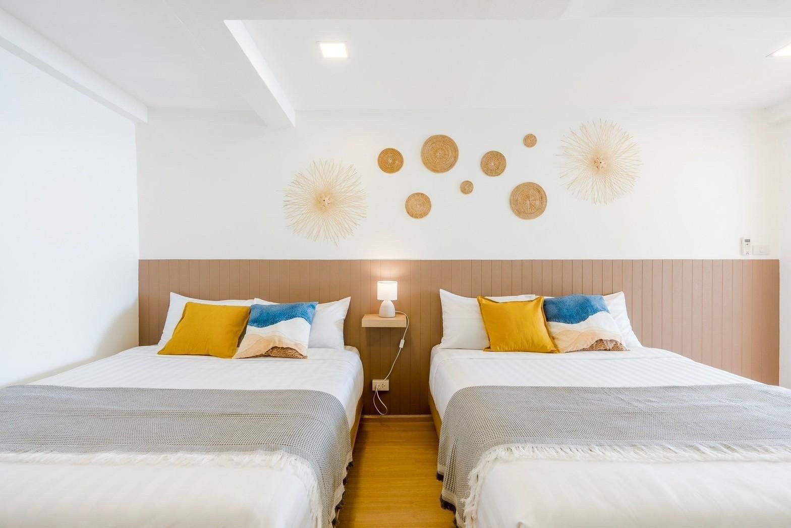 Twin beds with woven decor in Costa IV Beachfront Pool Villa, Cha-am, Phetchaburi. Comfortable sleeping arrangements.