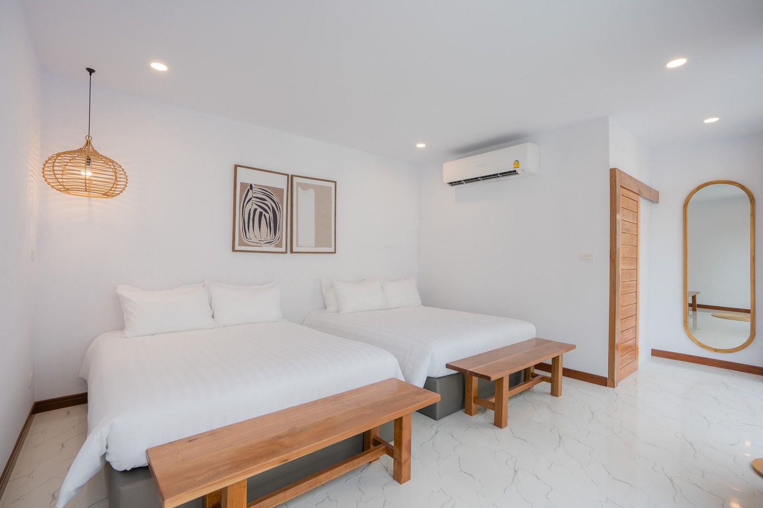 Bright bedroom with twin beds and wooden bench at Cross Sea VII Pool Villa, หาดคลองเทียน-ชะอำ. Minimalist decor.