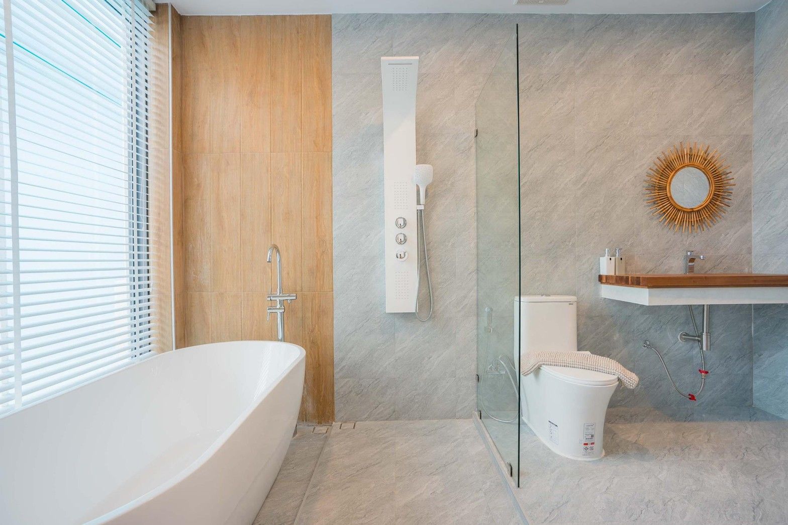 Modern bathroom with soaking tub, shower panel, and wood vanity at Cross Sea VII pool villa, หาดคลองเทียน-ชะอำ.
