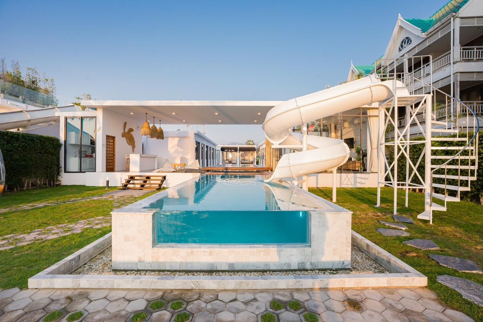 Cross Sea VII pool villa, Cha-am. Swimming pool with glass panel and waterslide feature.