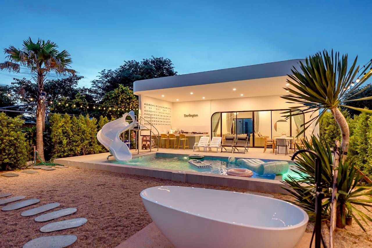 Darlington IV pool villa with water slide, swim-up bar, and outdoor bathtub. Perfect for a family vacation.