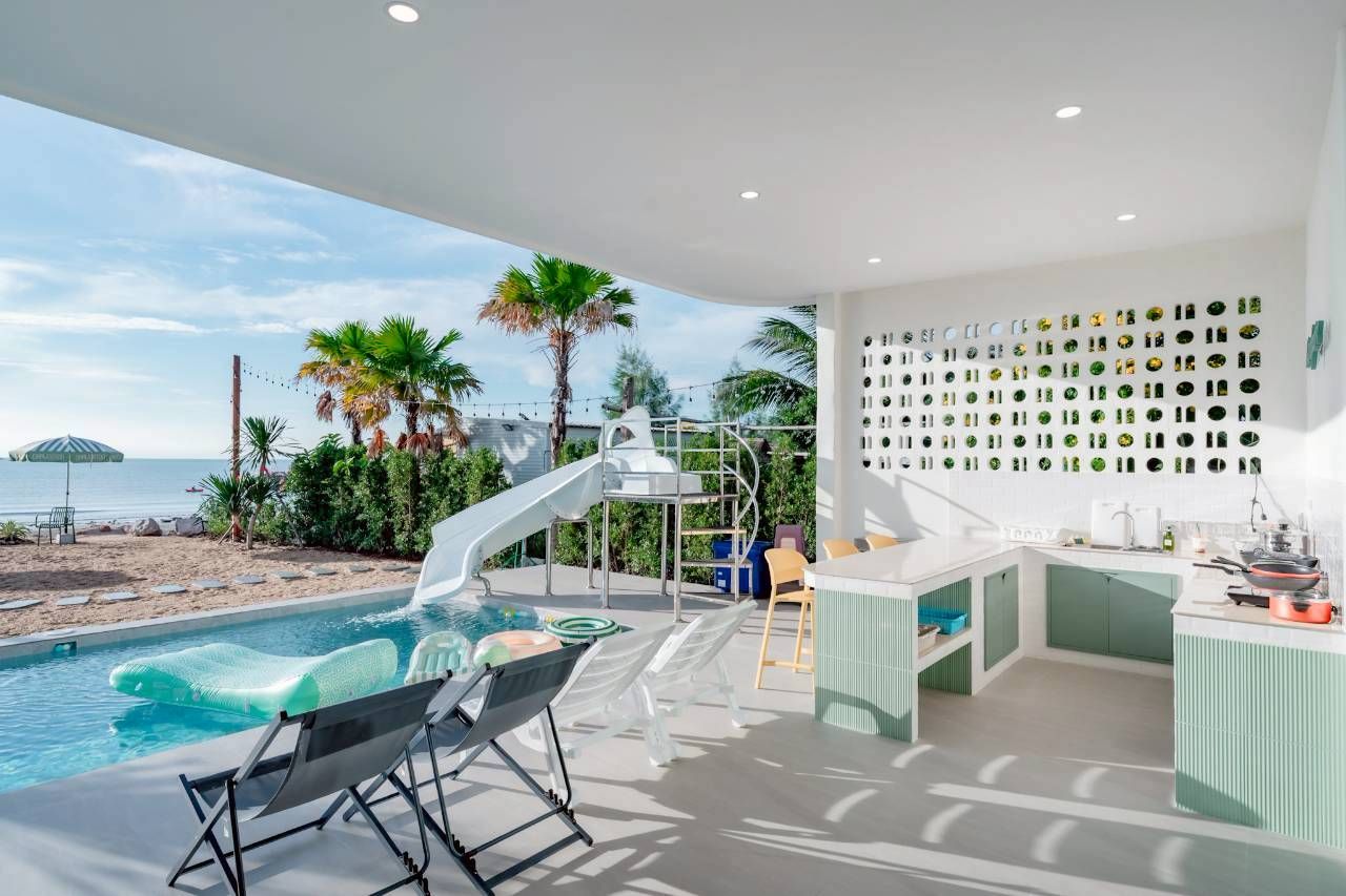 Darlington IV pool villa poolside kitchen and water slide. Beach view from the pool in this Thailand rental.