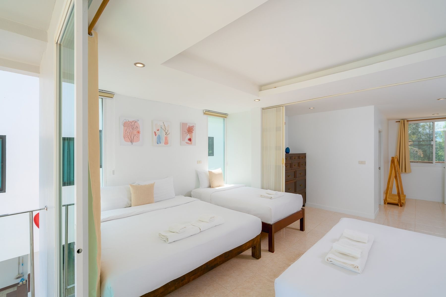 Bright bedroom with three beds at G Villa III Pool Villa, Pak Nam Pran, Pranburi. White linens and minimal decor.