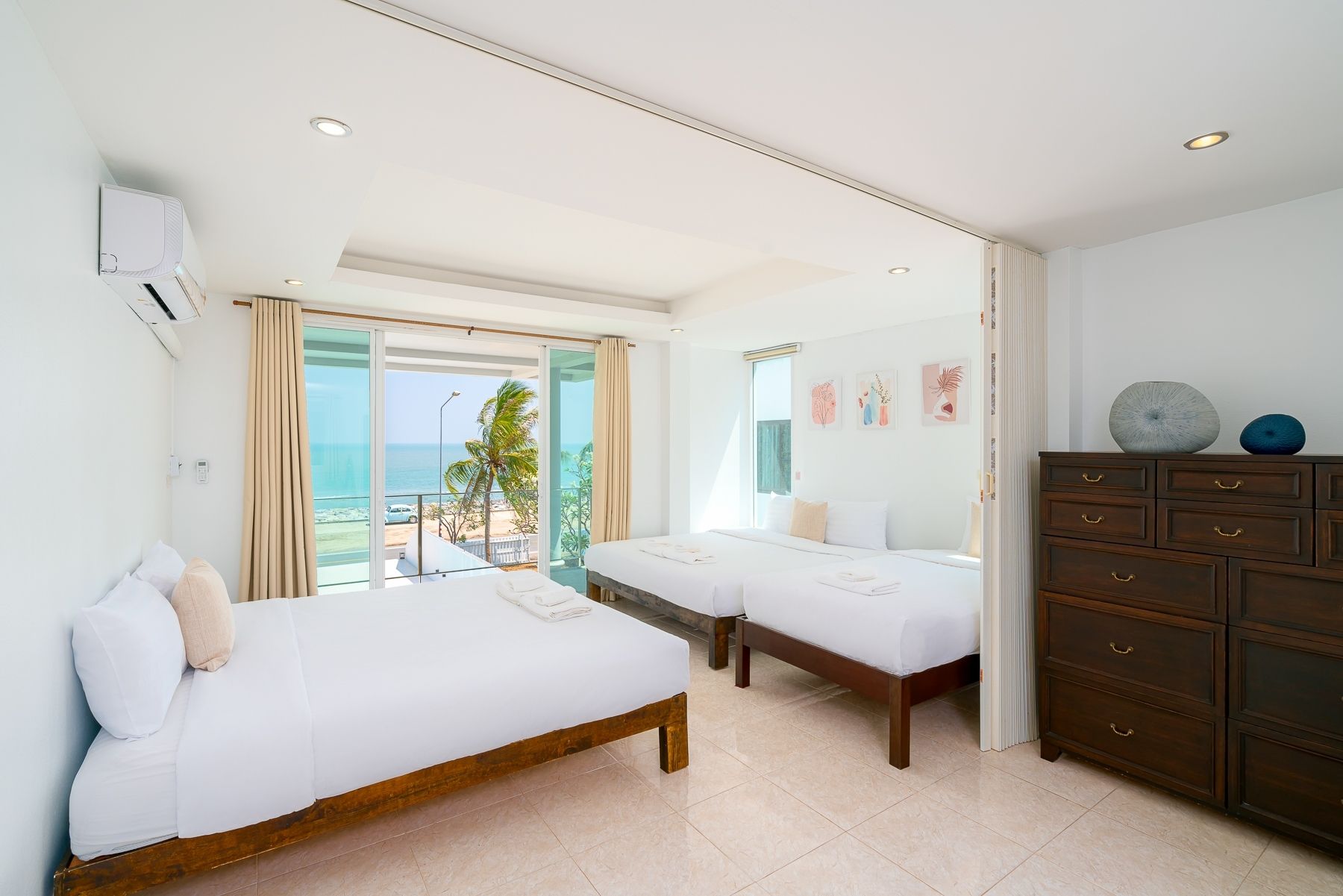 Bright bedroom with three single beds and ocean view at G Villa III Pool Villa, Pak Nam Pran, Pranburi.