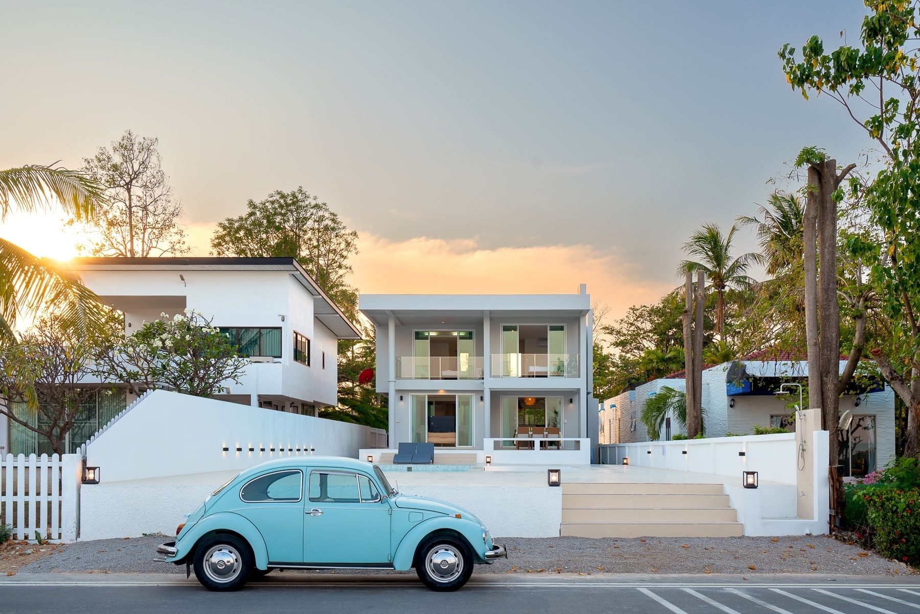 G Villa III Pool Villa in Pak Nam Pran, Pranburi, exterior view with a classic blue VW Beetle parked in front.