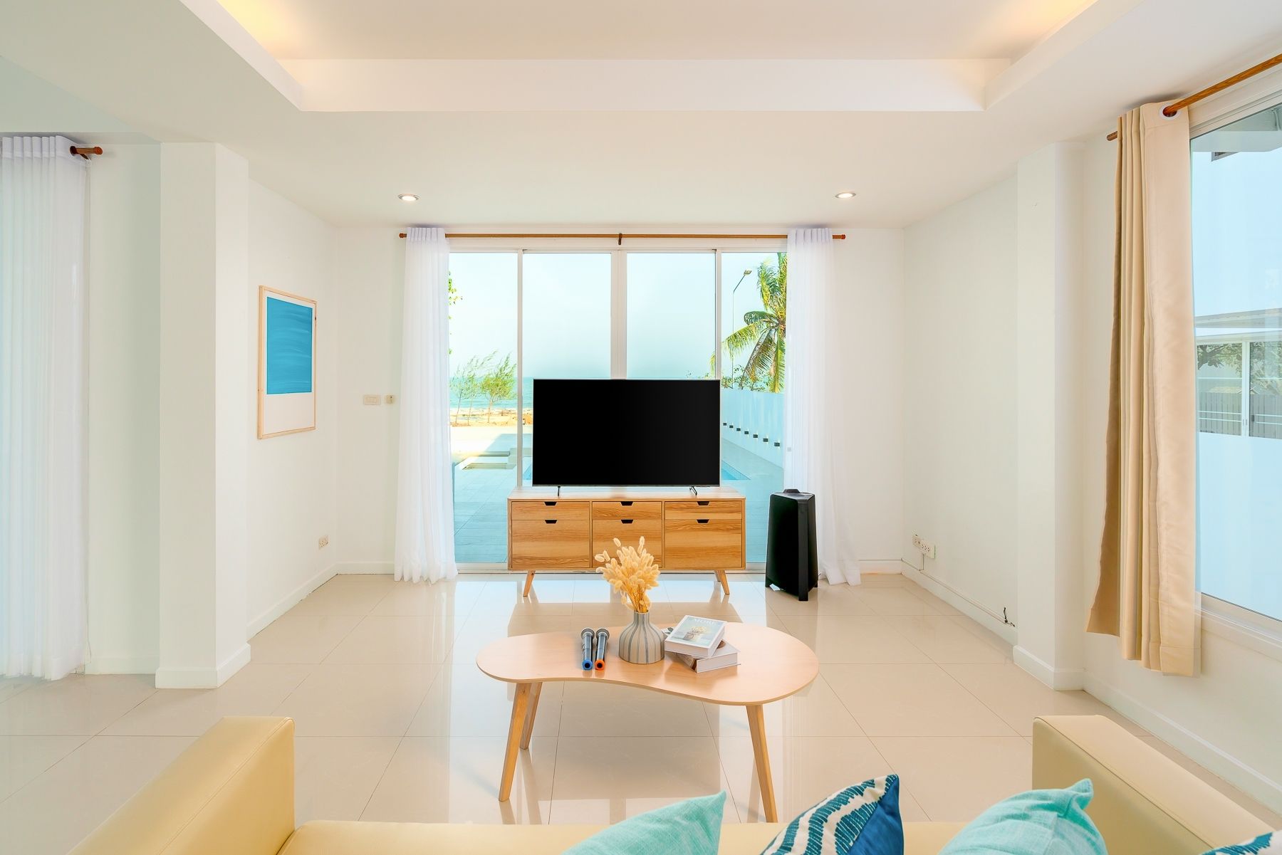 Bright living room at G Villa III Pool Villa, Pak Nam Pran. TV, sofa, and view of the pool area.