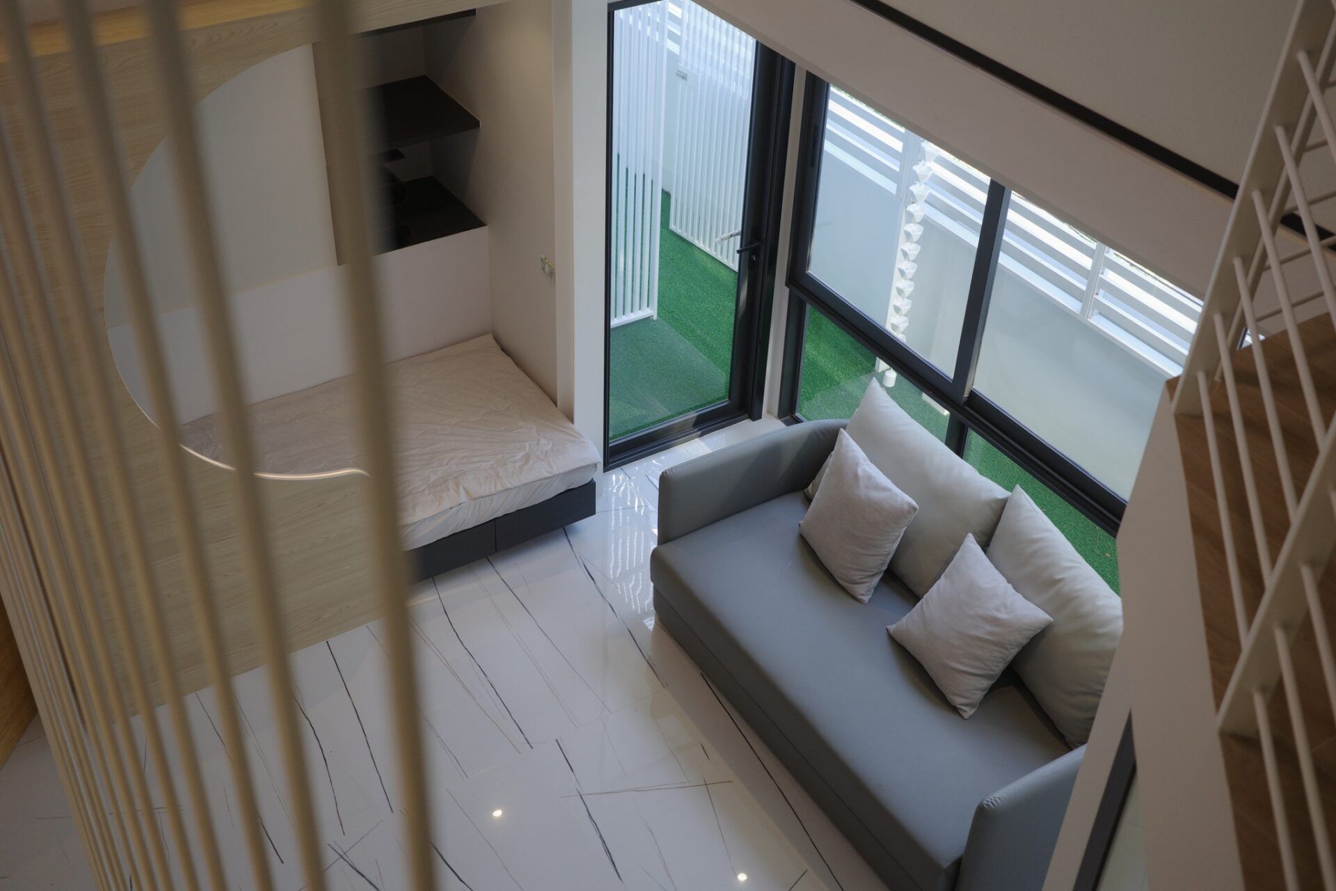 Daybed with pillows near window at Glass Beach III Pool Villa, หาดดงตาล พัทยาใต้. View of outdoor area.