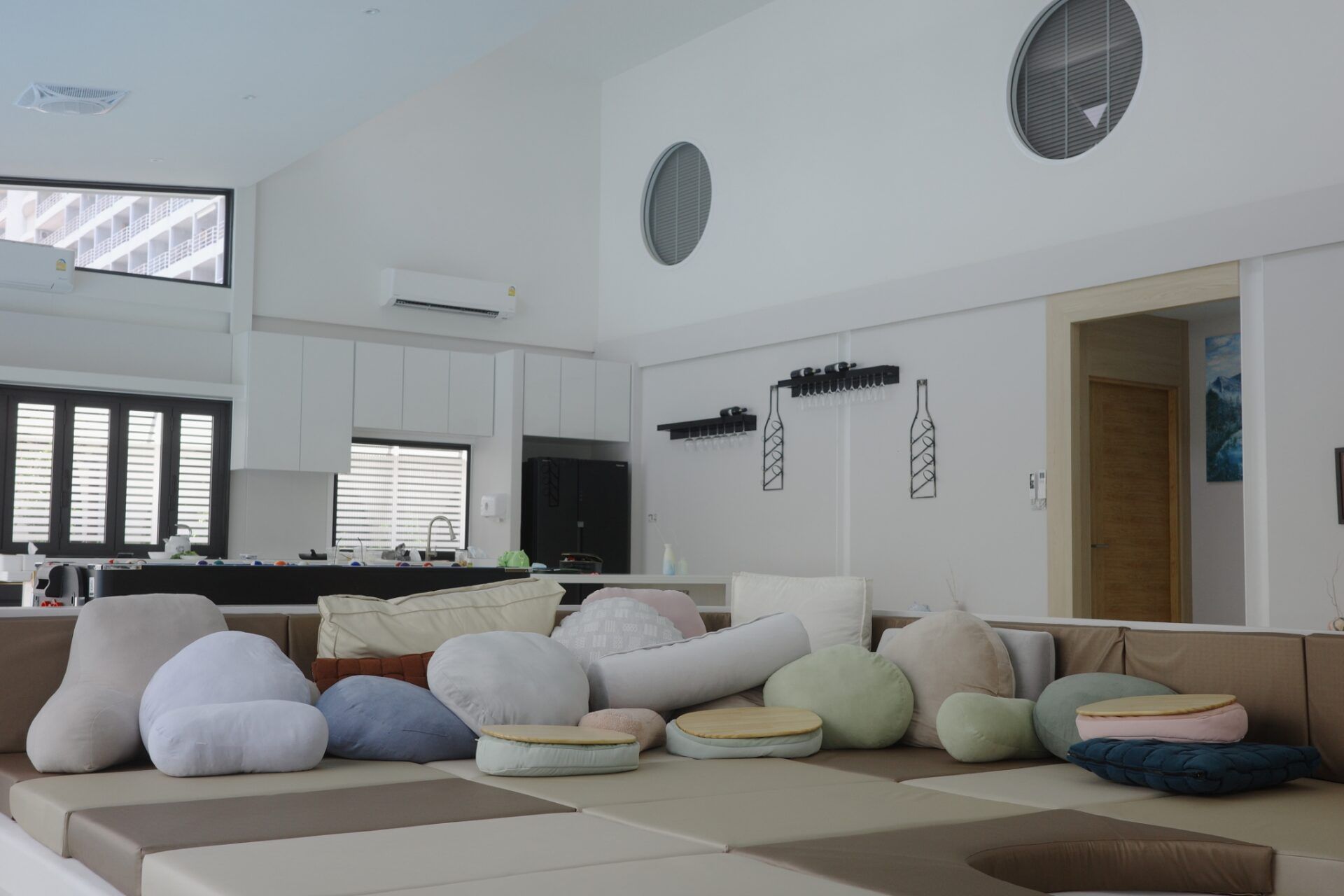 Unique modular sofa with decorative pillows in the living room of Glass Beach III Pool Villa, หาดดงตาล พัทยาใต้.