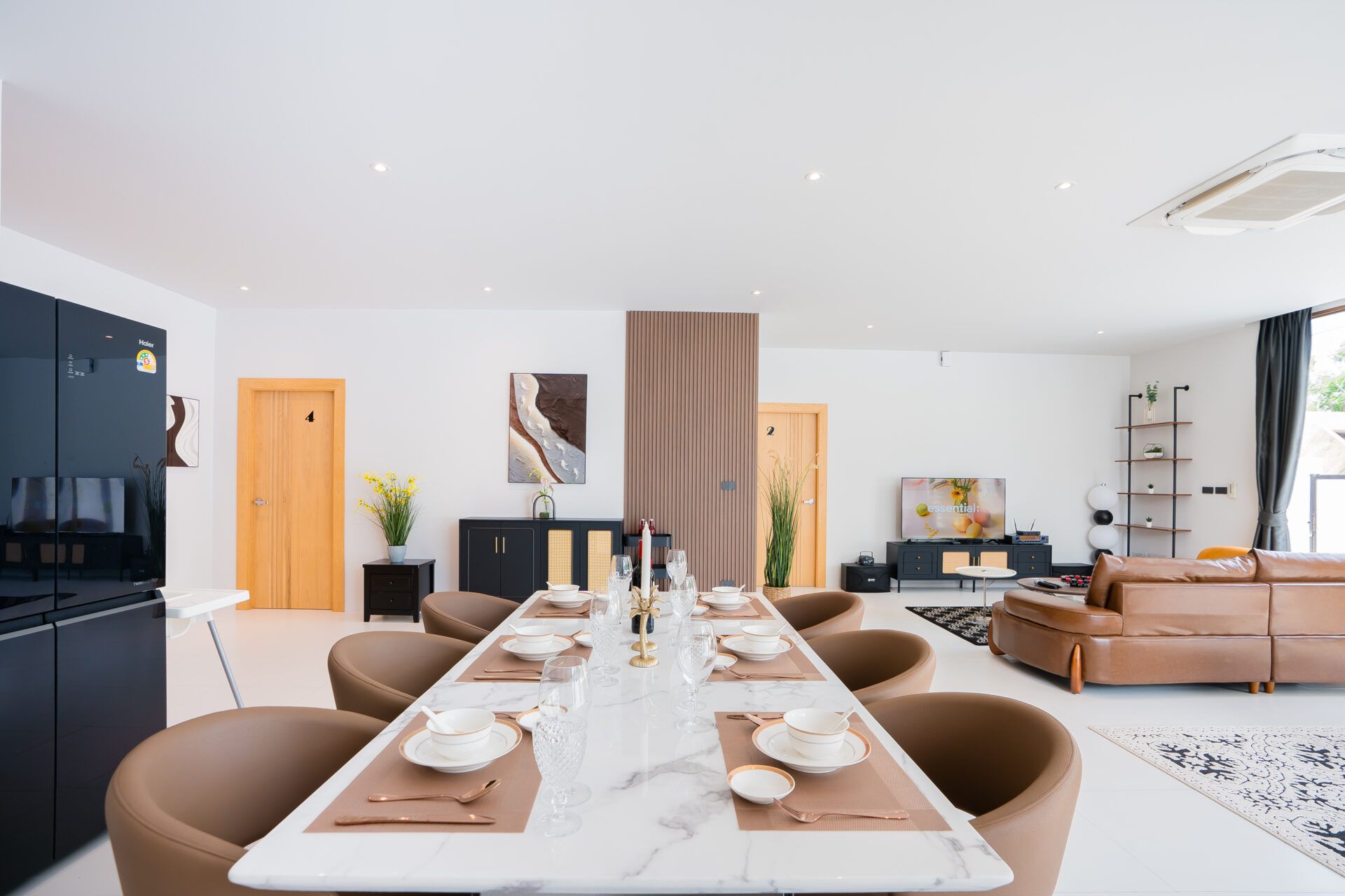 Formal dining table set for ten at Good Day V Pool Villa, South Pattaya near Jomtien beach. Modern open-concept living.