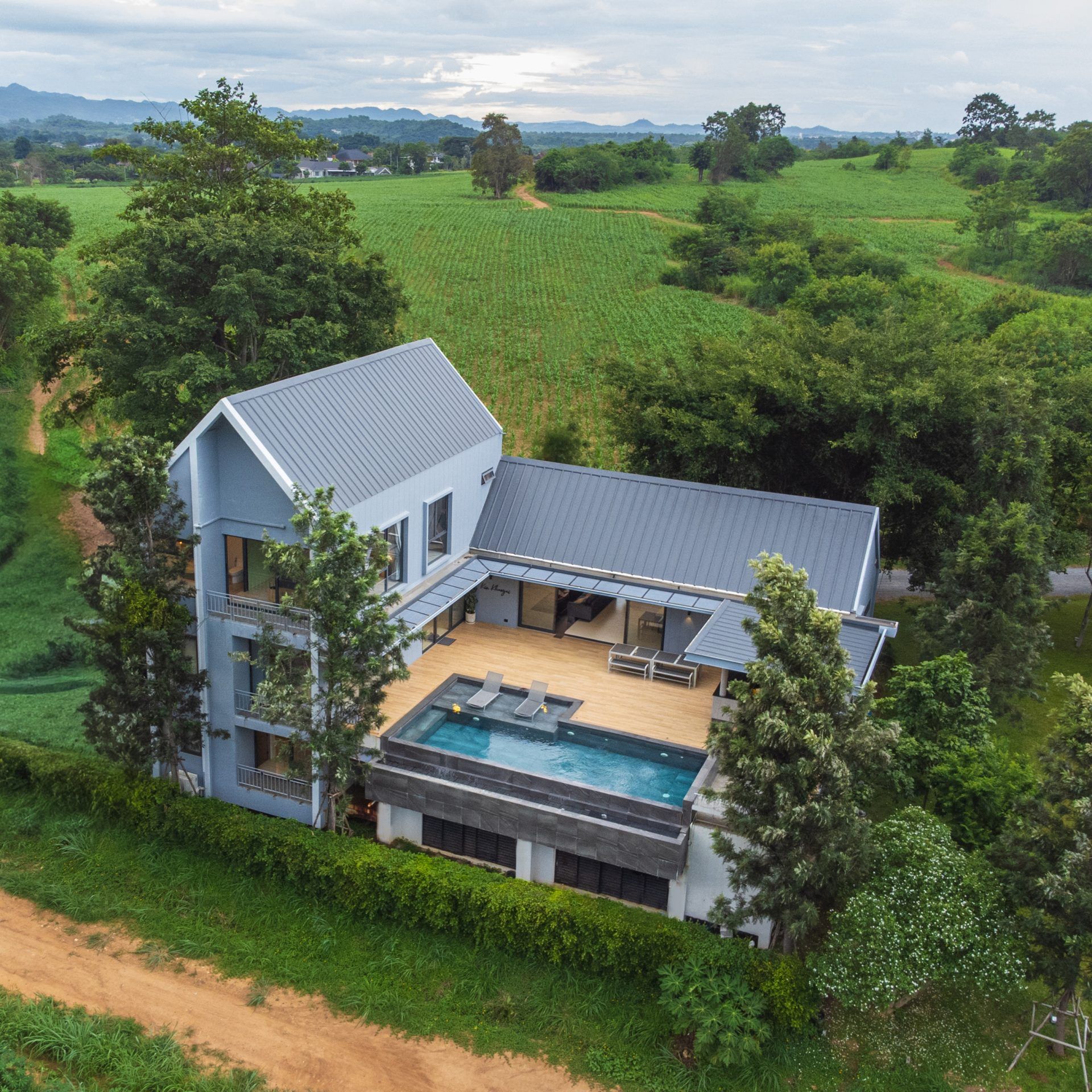 Aerial view of Kin Khaoyai V Pool Villa, หมูสี เขาใหญ่, showing the villa's architecture and surrounding landscape.