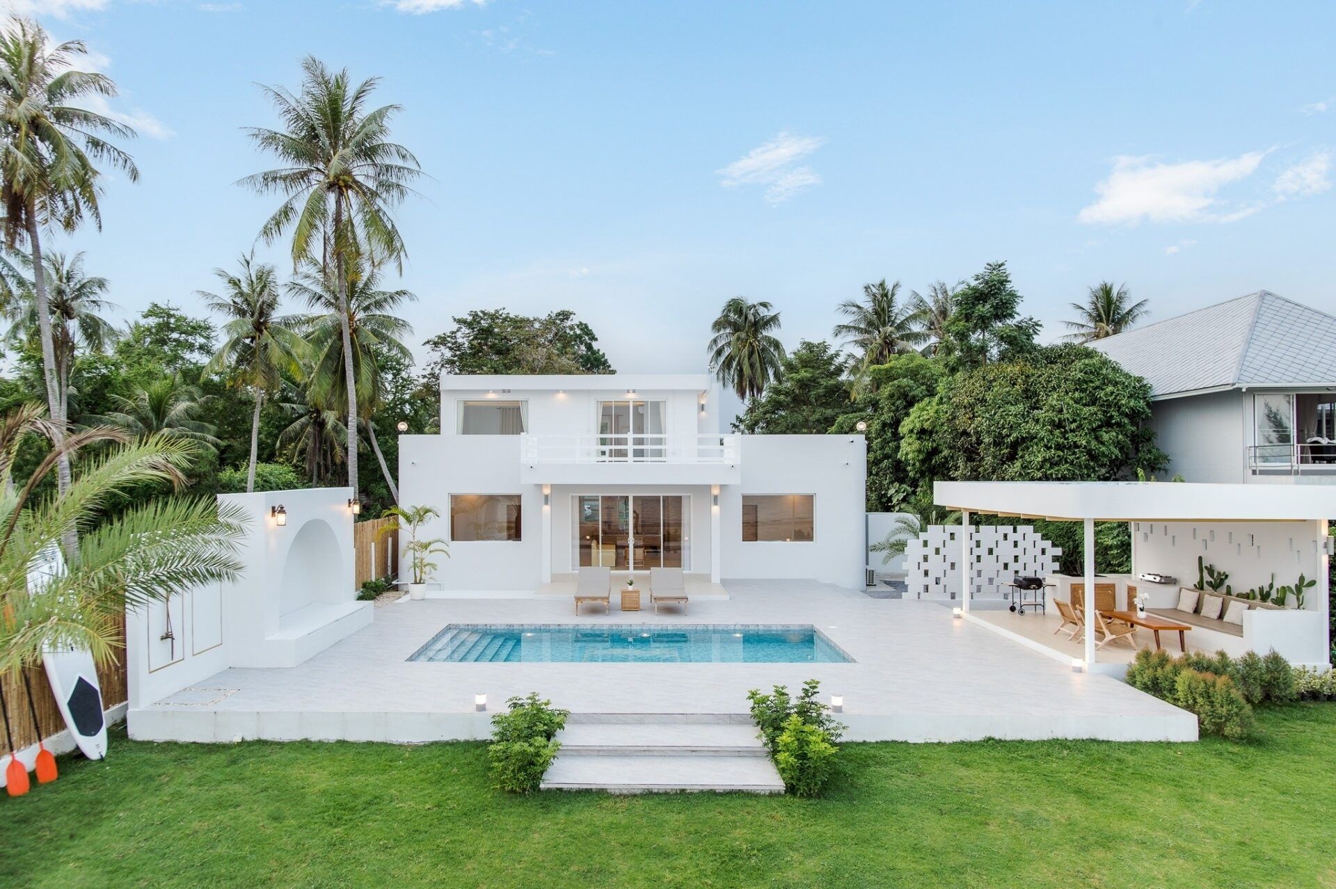 Exterior view of La Palma Villa Kuiburi, Thailand. Modern white villa with pool, terrace, and tropical landscaping.