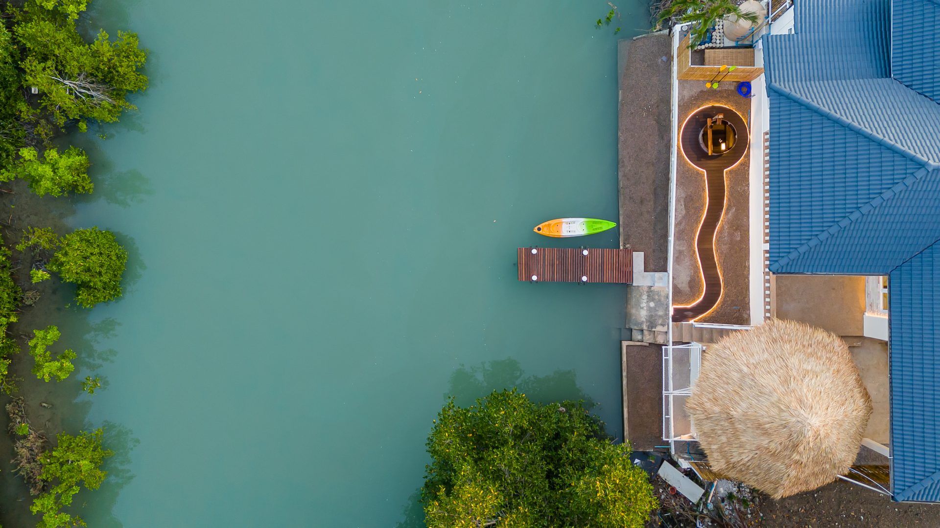 Aerial view of Lagoon Beach V Pool Villa near Bang Kao Beach, Cha-am, with kayak and dock access to the water.