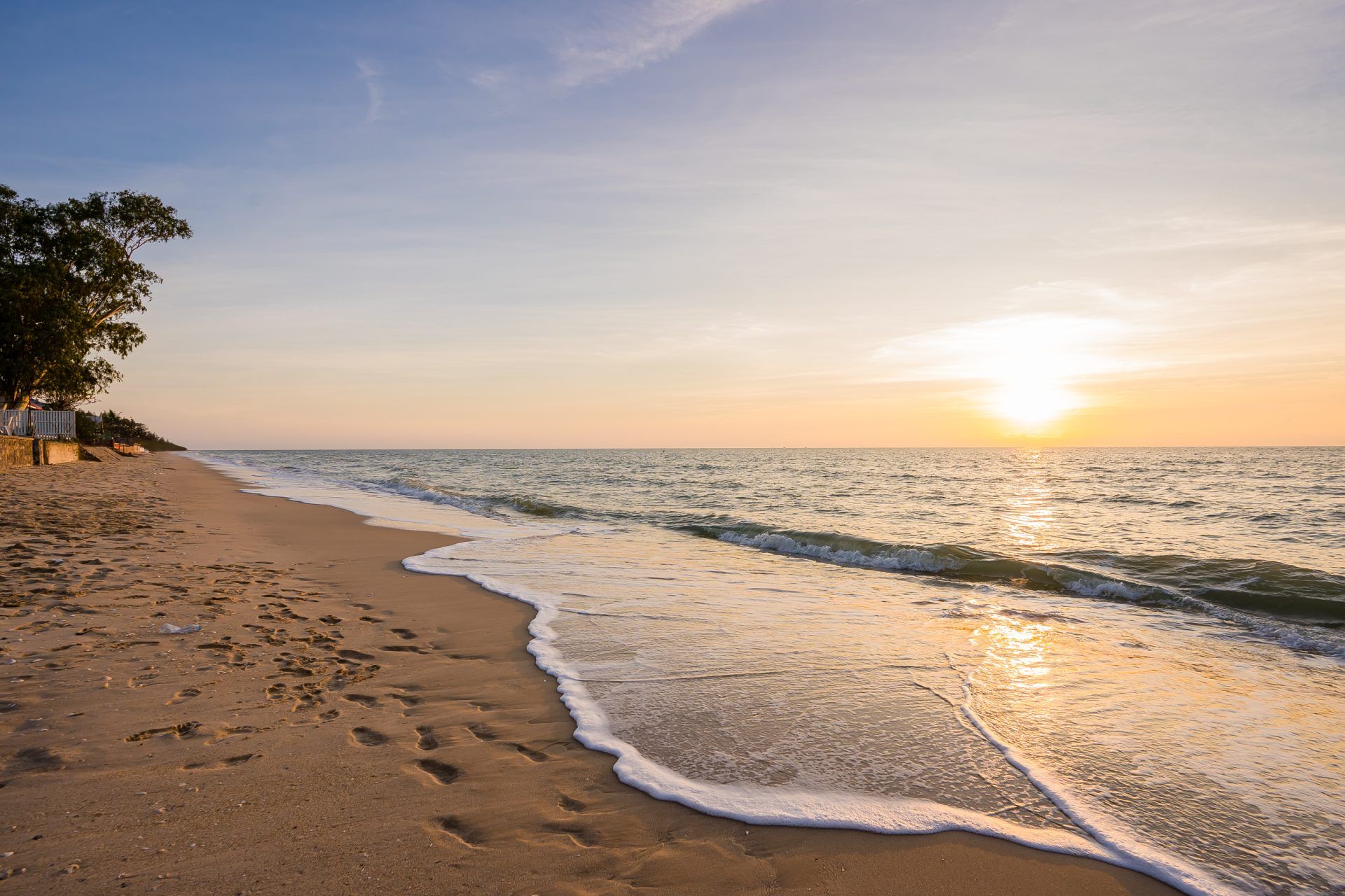 Sunset view from the beach near Lagoon Beach V Pool Villa, ใกล้หาดบางเก่า-ชะอำ. See the ocean waves and golden light.