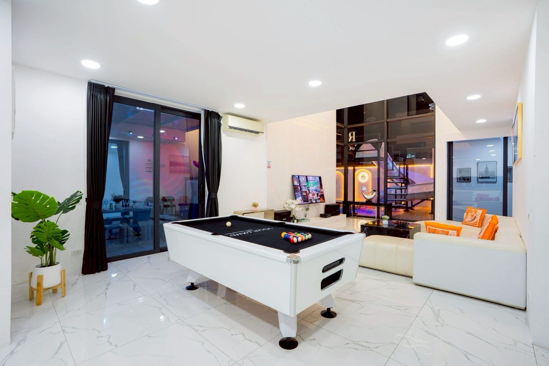 Double-height lobby entrance at night at Land VIII Pool Villa