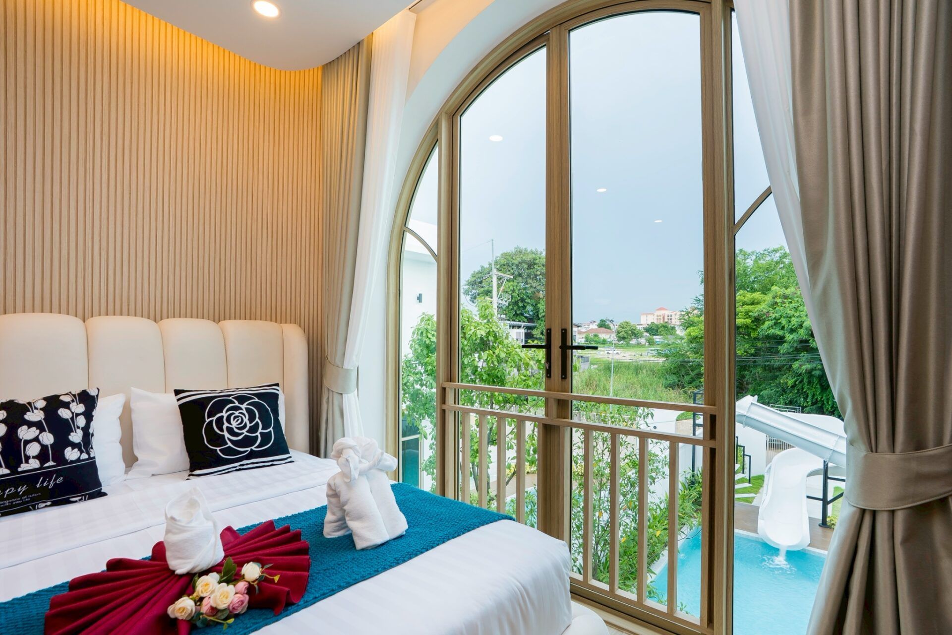 Villa exterior with spiral staircase and slide at Noble V