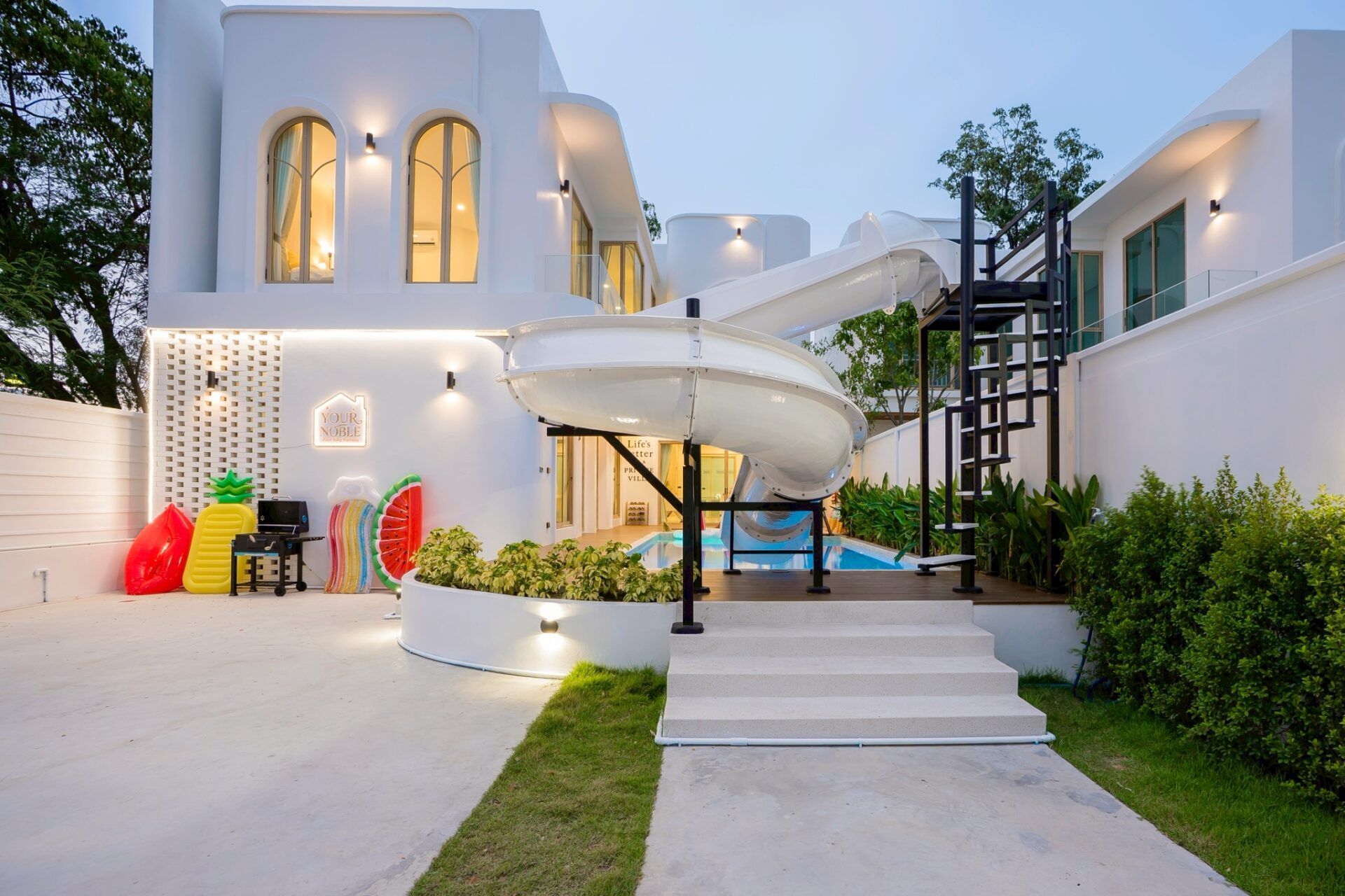 King bedroom with arched window at Noble V Pool Villa