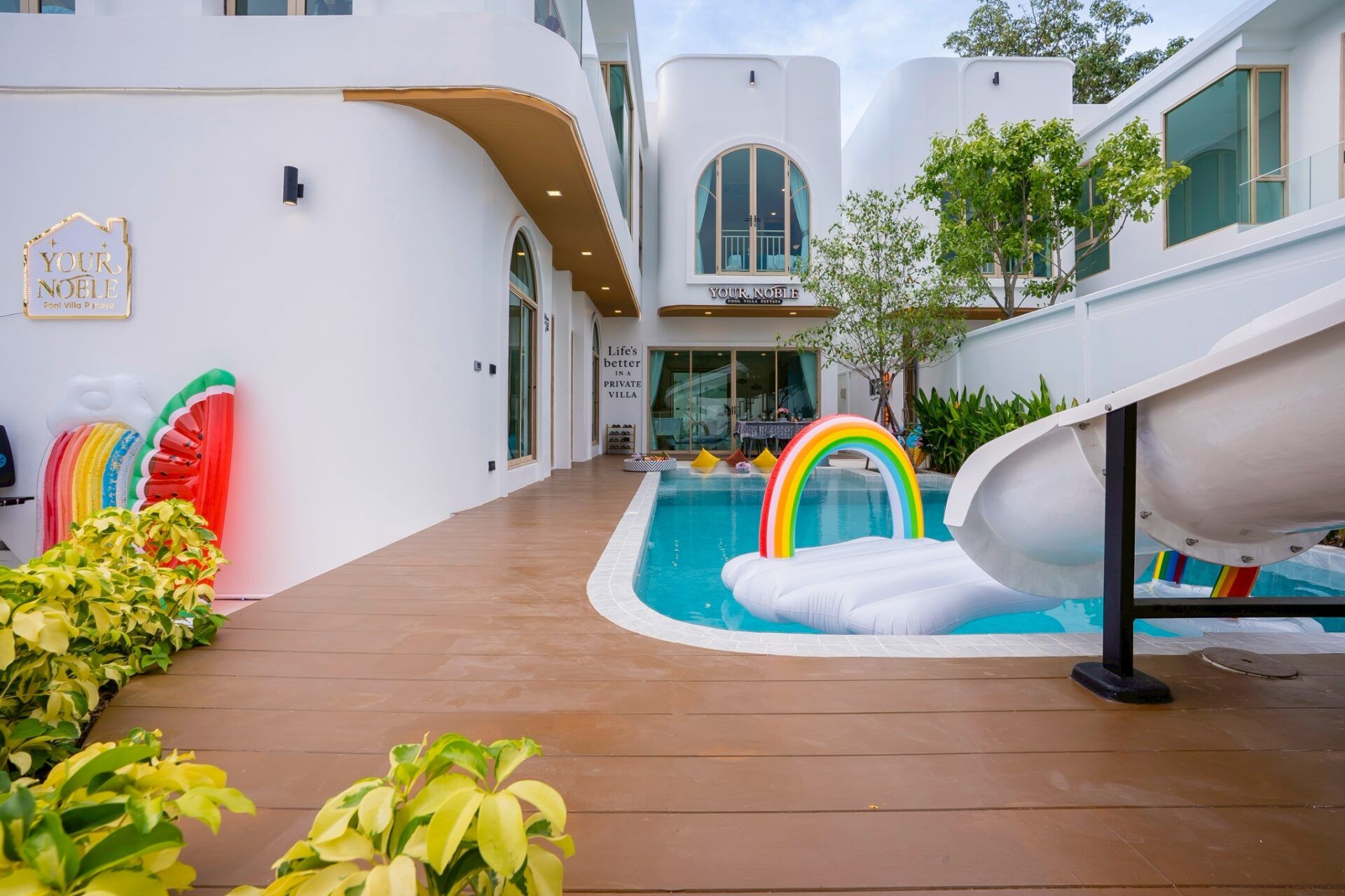 Pool courtyard with floats and deck at Noble V