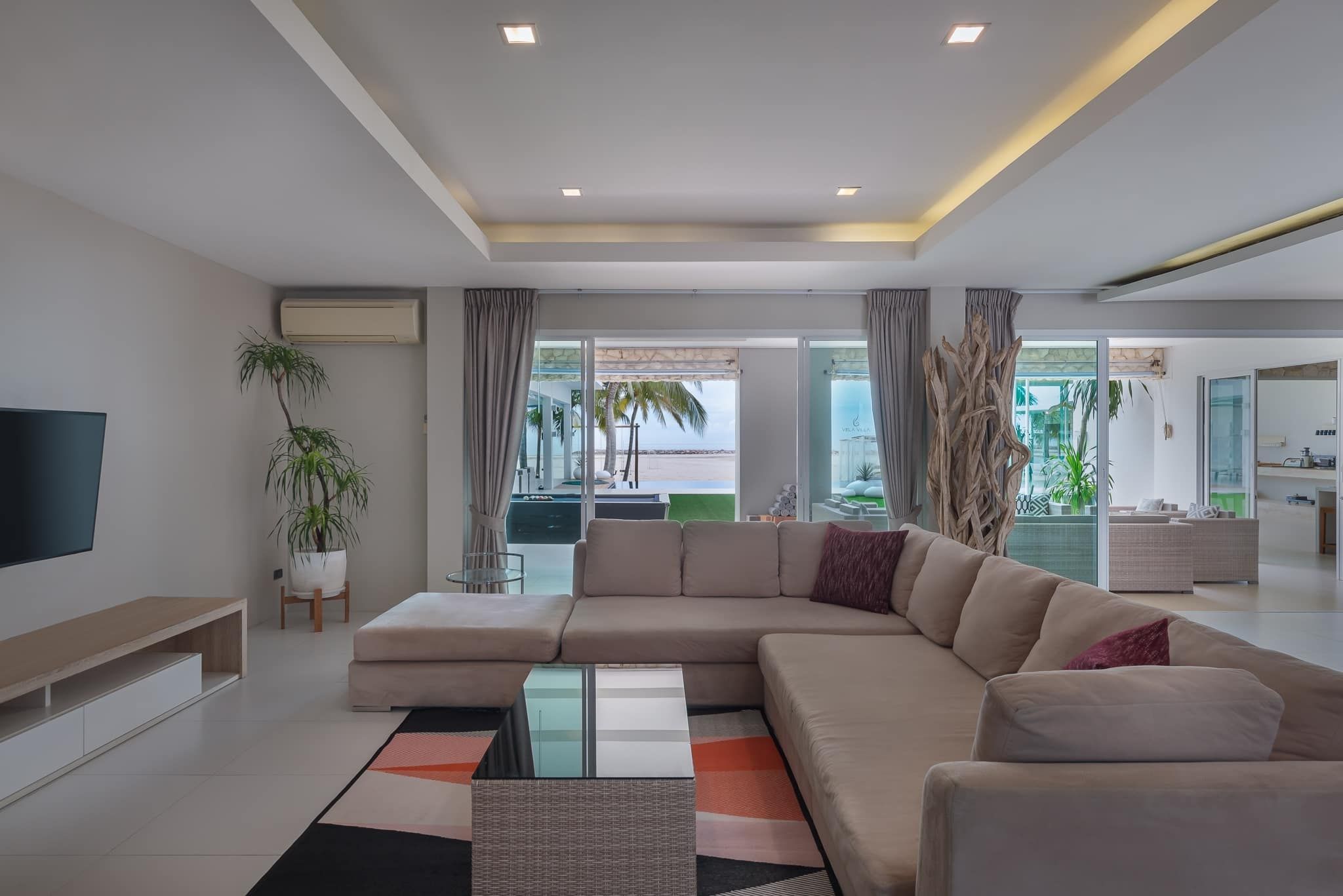 Vela VII Pool Villa, Cha-Am living room with large sofa and beach view.